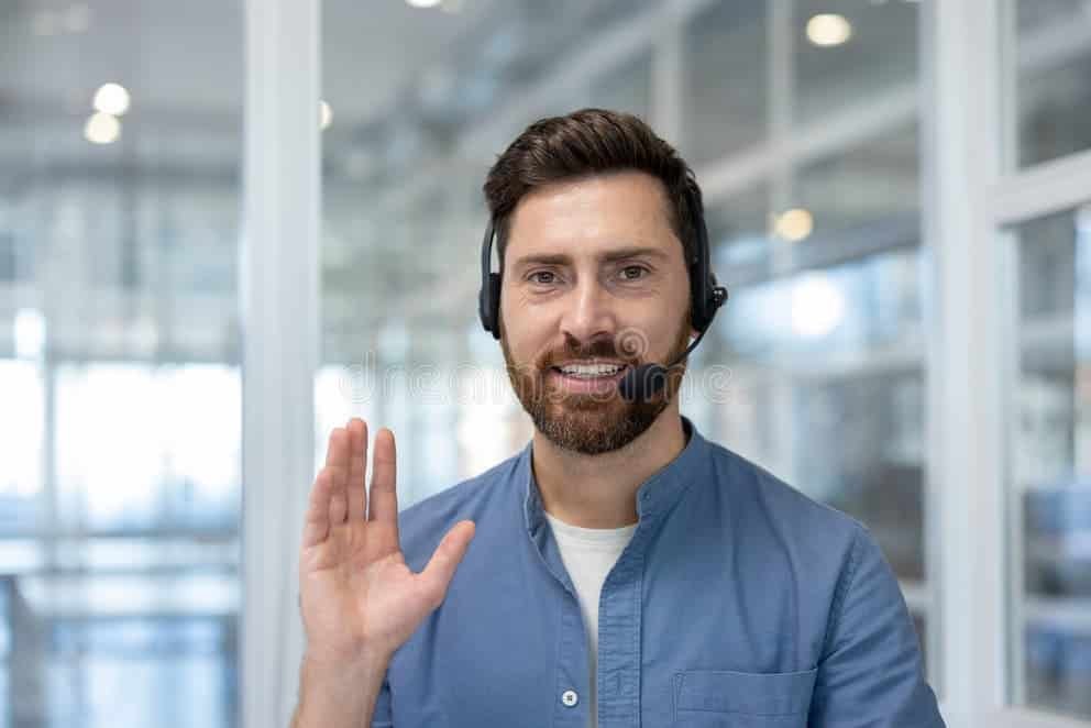 smiling-customer-service-representative-wearing-headset-modern-office-setting-friendly-male-professional-blue-shirt-397654714
